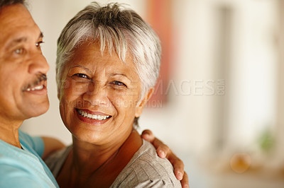 Buy stock photo Portrait of a mature couple embracing at home