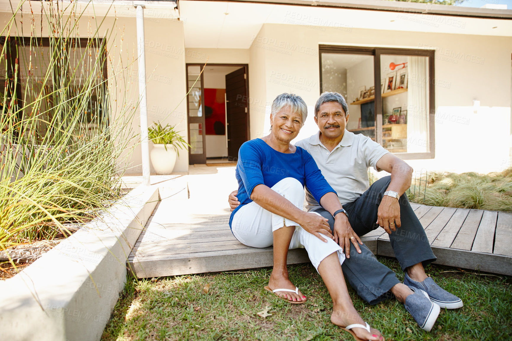 Buy stock photo Shot of a happy senior couple enjoying spending time together in their backyard