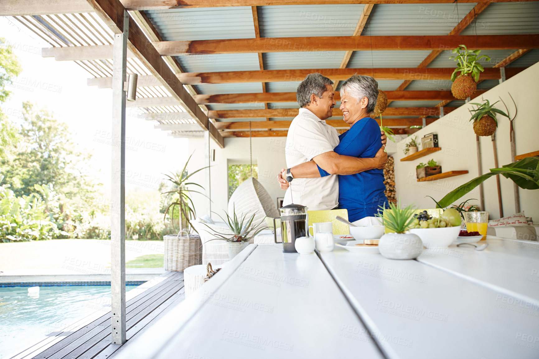 Buy stock photo Shot of a happy senior couple wrapped in a warm embrace at home