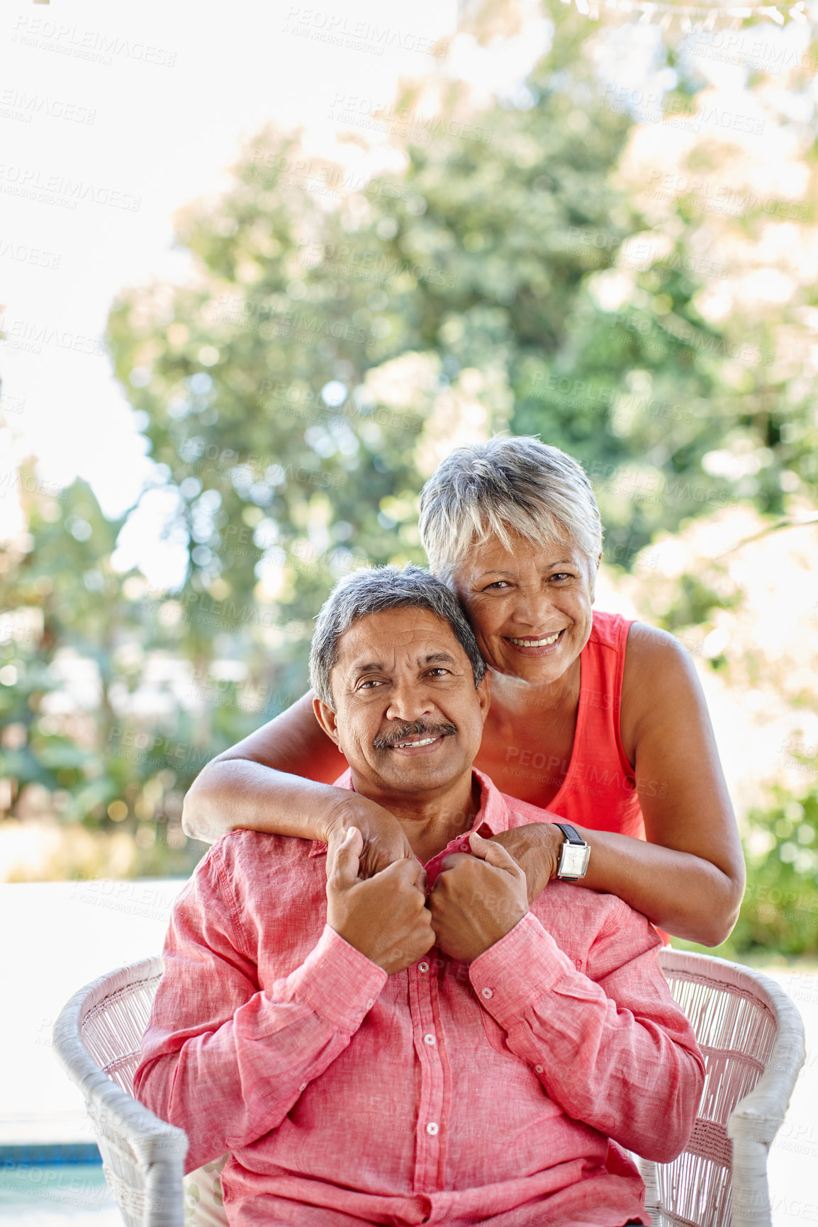 Buy stock photo Portrait, senior couple and hug outdoor for love, loyalty and commitment to partner on garden chair. Retirement, happy man and woman embrace for strong relationship, support and connection in Mexico