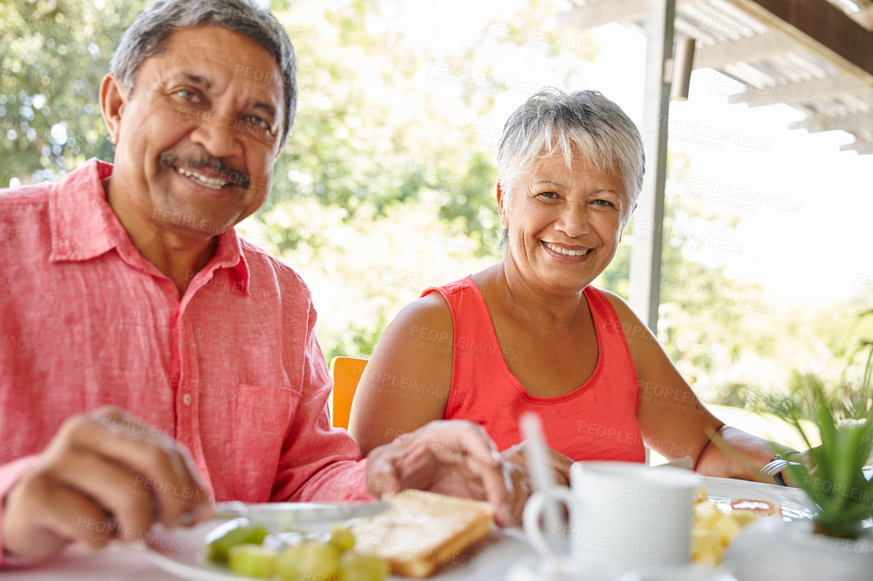 Buy stock photo Shot of a happy senior couple enjoying a leisurely breakfast together at home