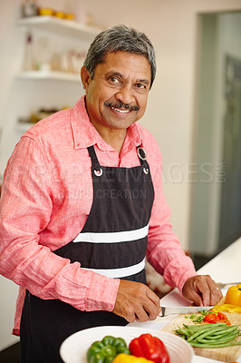 Buy stock photo Portrait of a happy senior man cooking a healthy meal at home