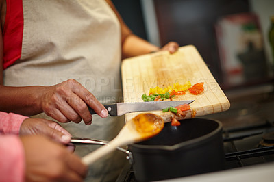 Buy stock photo Closeup shot of two people cooking a meal together at home