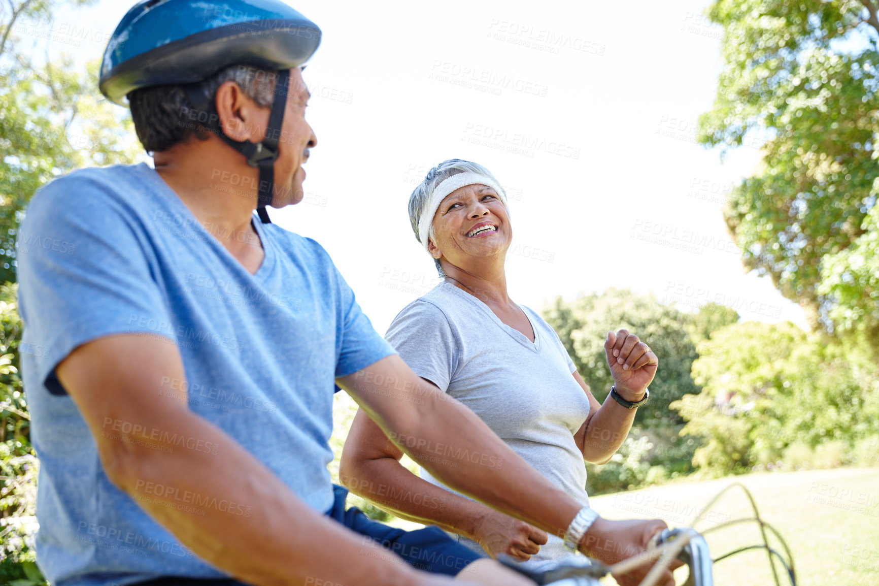 Buy stock photo Shot of a happy senior couple going for a bike ride and a jog together outdoors
