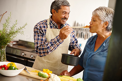 Buy stock photo Shot of a happy senior couple cooking a healthy meal together at home