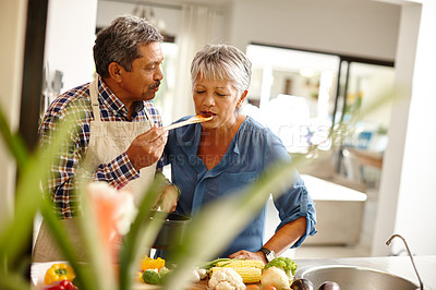 Buy stock photo Shot of a happy senior couple cooking a healthy meal together at home