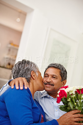 Buy stock photo Shot of a loving senior man giving his wife a bunch of flowers