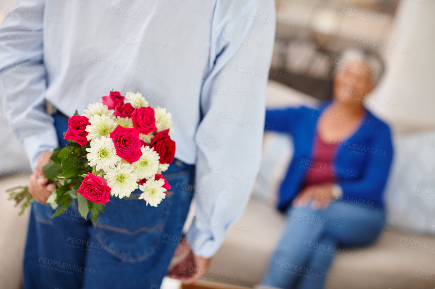 Buy stock photo Shot of a senior woman receiving a surprise bunch of flowers from her husband