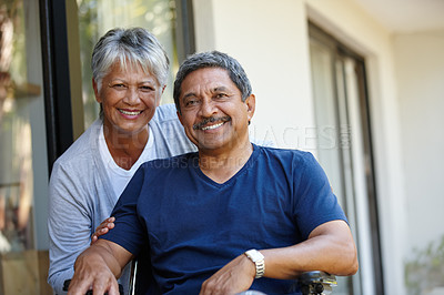 Buy stock photo Portrait of a senior woman pushing her husband in a wheelchair outdoors