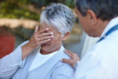 Buy stock photo Cropped shot of a senior woman getting some bad news from her doctor