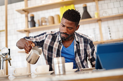 Buy stock photo Cropped shot of a handsome male barista preparing coffee behind a cafe counter