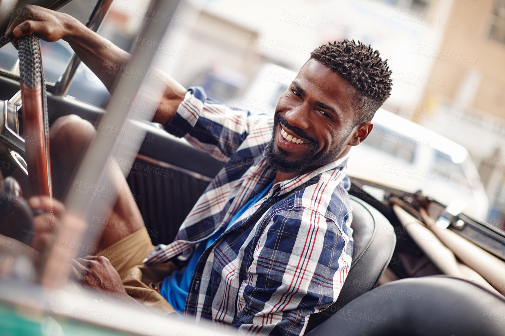 Buy stock photo Shot of a happy young man driving in his convertible