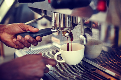 Buy stock photo Closeup shot of a male barista using an espresso machine to make a cup of coffee