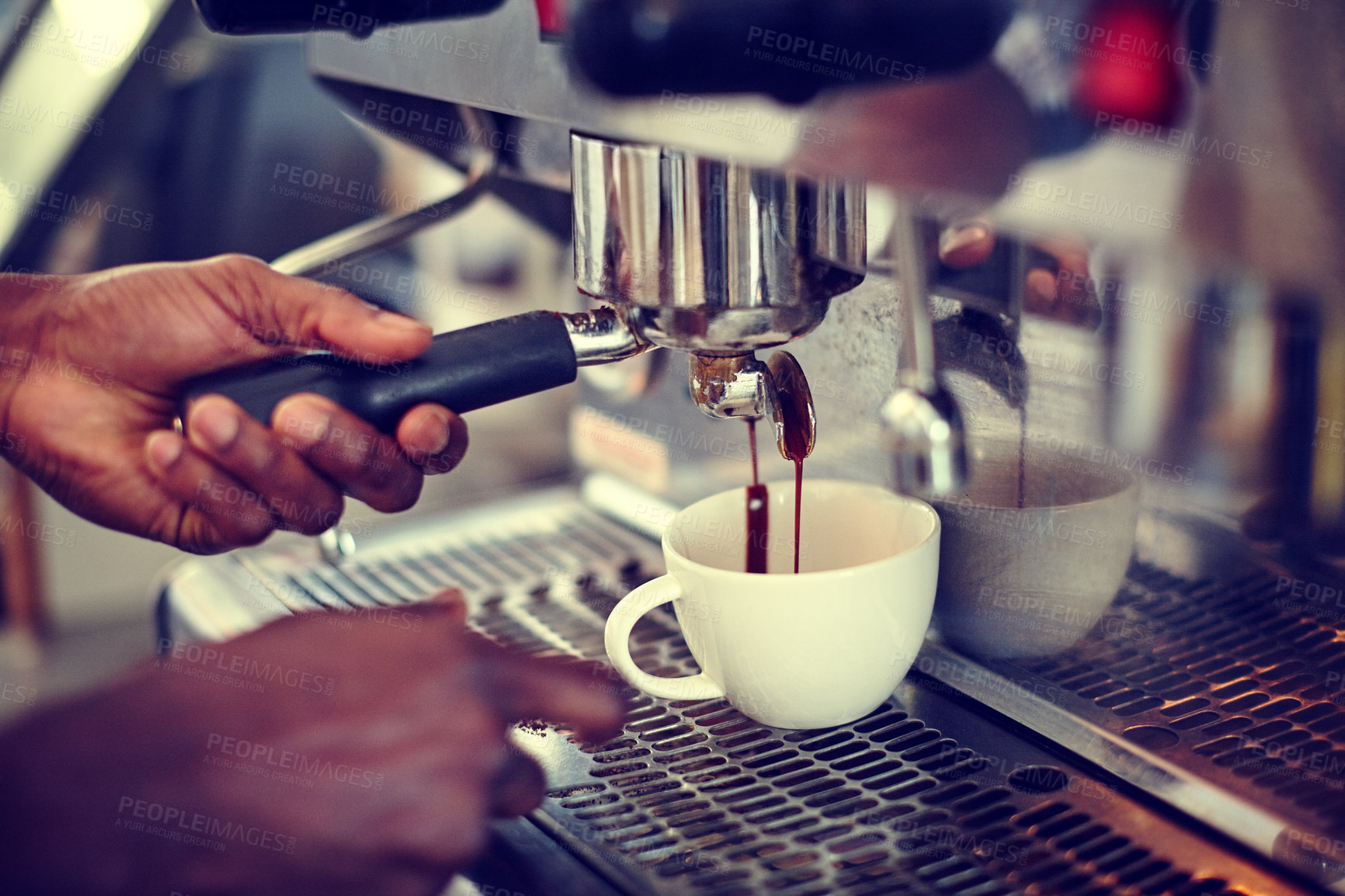 Buy stock photo Closeup shot of a male barista using an espresso machine to make a cup of coffee