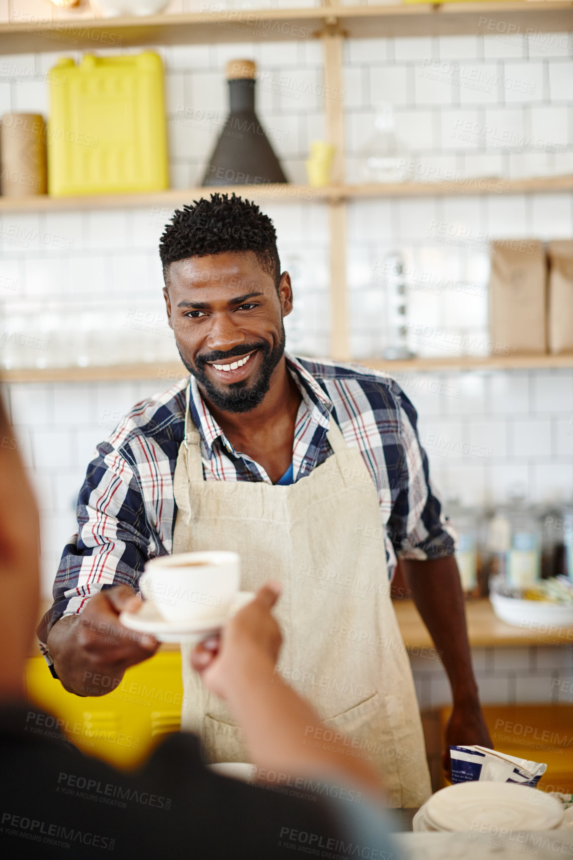 Buy stock photo Cropped shot of a handsome young man serving a customer in his coffee shop
