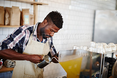 Buy stock photo Cropped shot of a handsome male barista using an espresso machine in a cafe