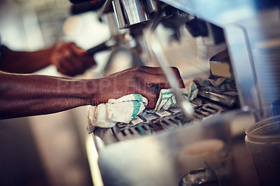 Buy stock photo Closeup shot of a barista cleaning an espresso machine at a cafe