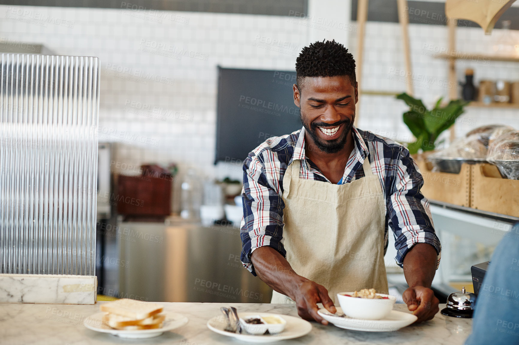 Buy stock photo Cropped shot of a handsome young man working in a cafe