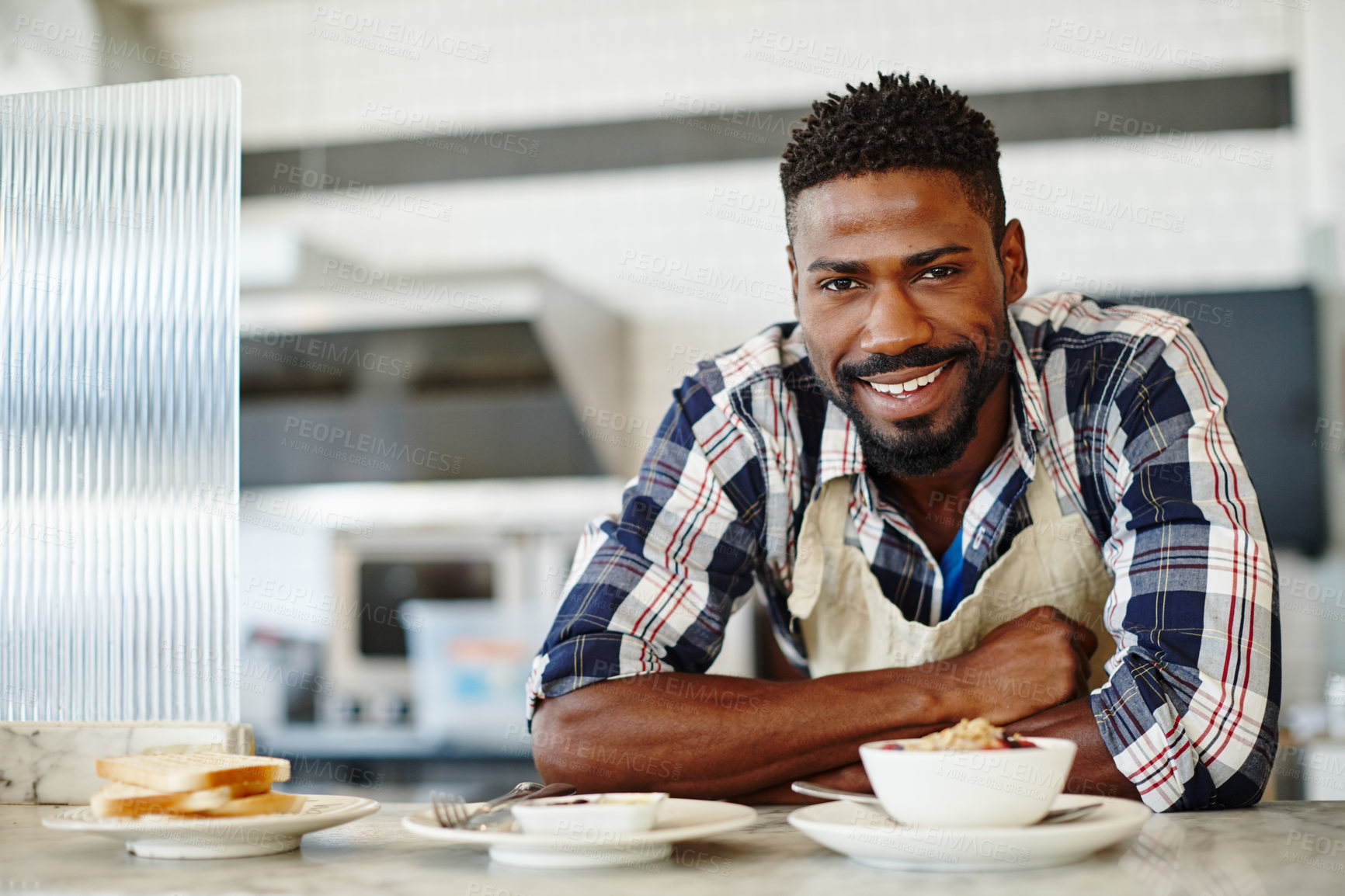 Buy stock photo Cropped portrait of a handsome young man working in a coffee shop