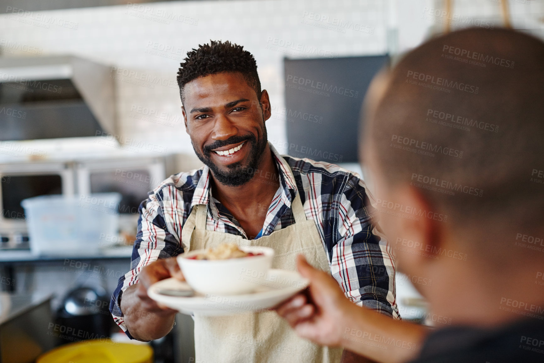 Buy stock photo Cropped shot of a young man serving a customer at a cafe