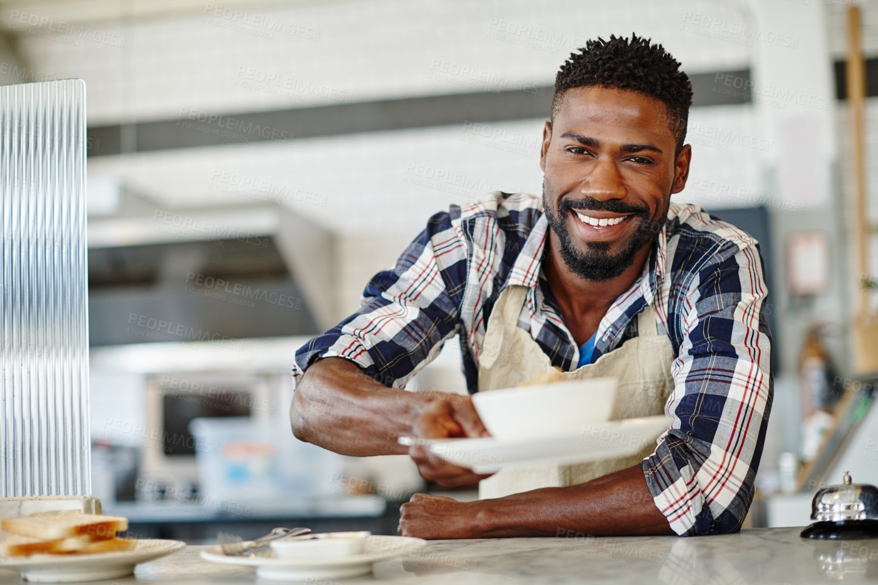 Buy stock photo Cropped portrait of a handsome young man serving you breakfast at a cafe