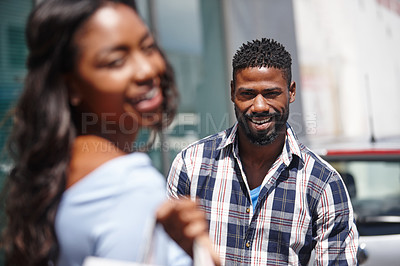 Buy stock photo Shot of a handsome man posing with his girlfriend in the foreground