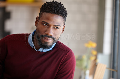 Buy stock photo A young african man sitting in a coffee shop