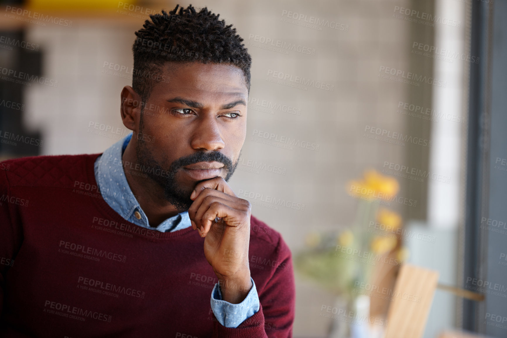 Buy stock photo A young african man sitting in a coffee shop