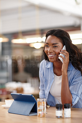 Buy stock photo Cropped shot of an attractive woman sitting in a coffee shop using a cellphone and tablet