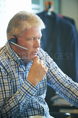 Buy stock photo Senior businessman, face and thinking at call center for decision, choice or customer service at office. Mature man, consultant or agent in wonder with headphones for online advice or help workplace