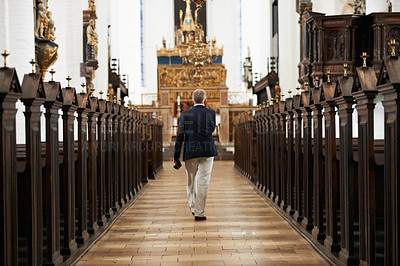 Buy stock photo Walking, aisle and senior man in a church for sightseeing on a weekend trip, vacation or holiday. Faith, religion and back of holy elderly male person in retirement in worship cathedral in the city.