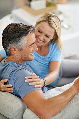 Buy stock photo Shot of a mature couple laughing while relaxing at home
