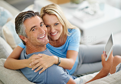 Buy stock photo Couch, hug and couple with tablet, portrait and watch of movie, browsing and subscription for entertainment. House, man and woman with app, streaming and happy in living room, embrace and bonding