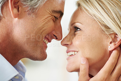 Buy stock photo Shot of a mature couple sharing a tender moment together at home