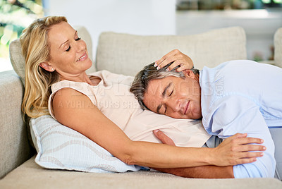 Buy stock photo Shot of a mature couple sharing a tender moment together while relaxing at home