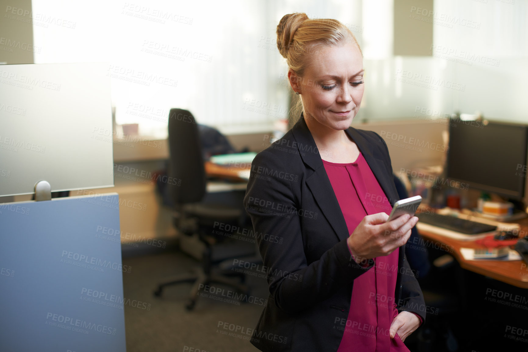 Buy stock photo Cropped shot of an attractive businesswoman using he cellphone in the office