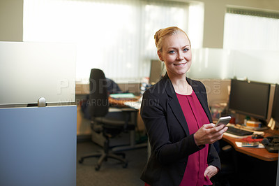 Buy stock photo Portrait of an attractive businesswoman using he cellphone in the office