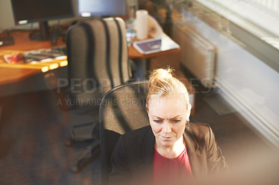 Buy stock photo High angle shot of an attractive businesswoman using her work computer