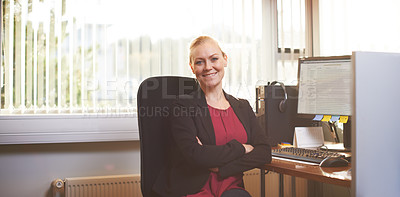 Buy stock photo Portrait of an attractive businesswoman sitting with her arms crossed in the office