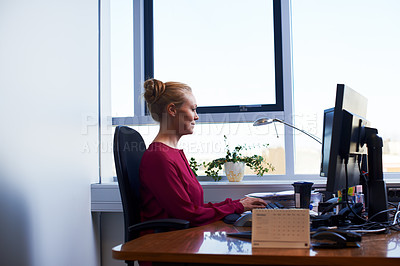 Buy stock photo Cropped shot of an attractive businesswoman using her work computer