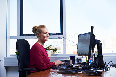 Buy stock photo Cropped shot of an attractive businesswoman using her work computer