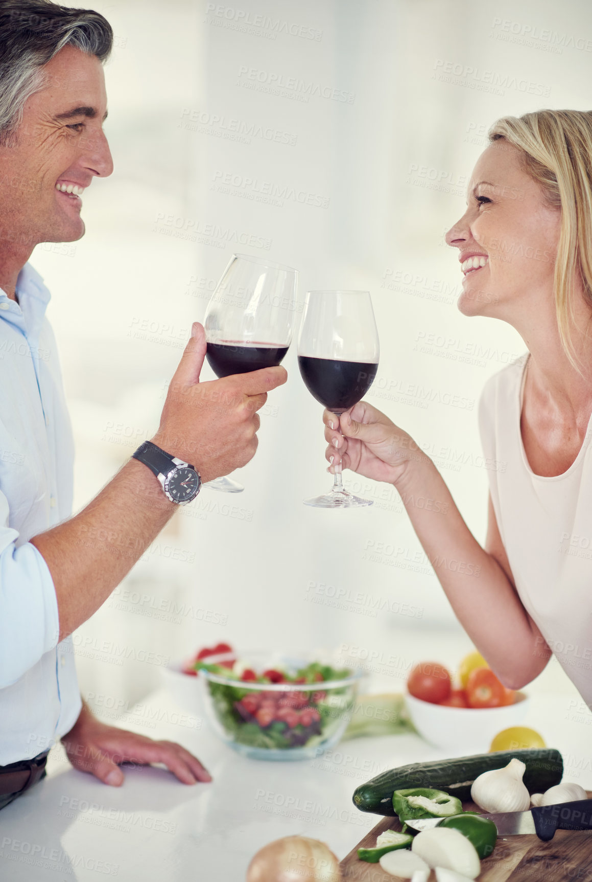 Buy stock photo Mature man, happy woman and wine toast with bonding, laugh and together for love in kitchen. Married couple, celebration and cheers with alcohol for healthy meal, nutrition or romantic dinner in home