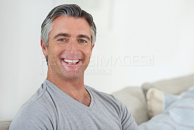 Buy stock photo Mature man, portrait and sofa in home, happy and confidence with pride, relax and morning in living room. Person, smile and ready to start day with face on lounge couch at apartment in Switzerland