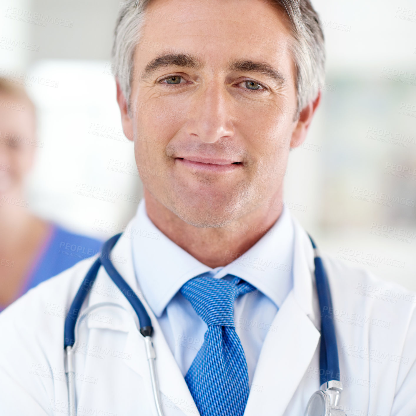 Buy stock photo Portrait of a male doctor with a colleague standing in a the background