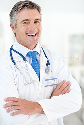 Buy stock photo Portrait of a male doctor standing in a hospital corridor