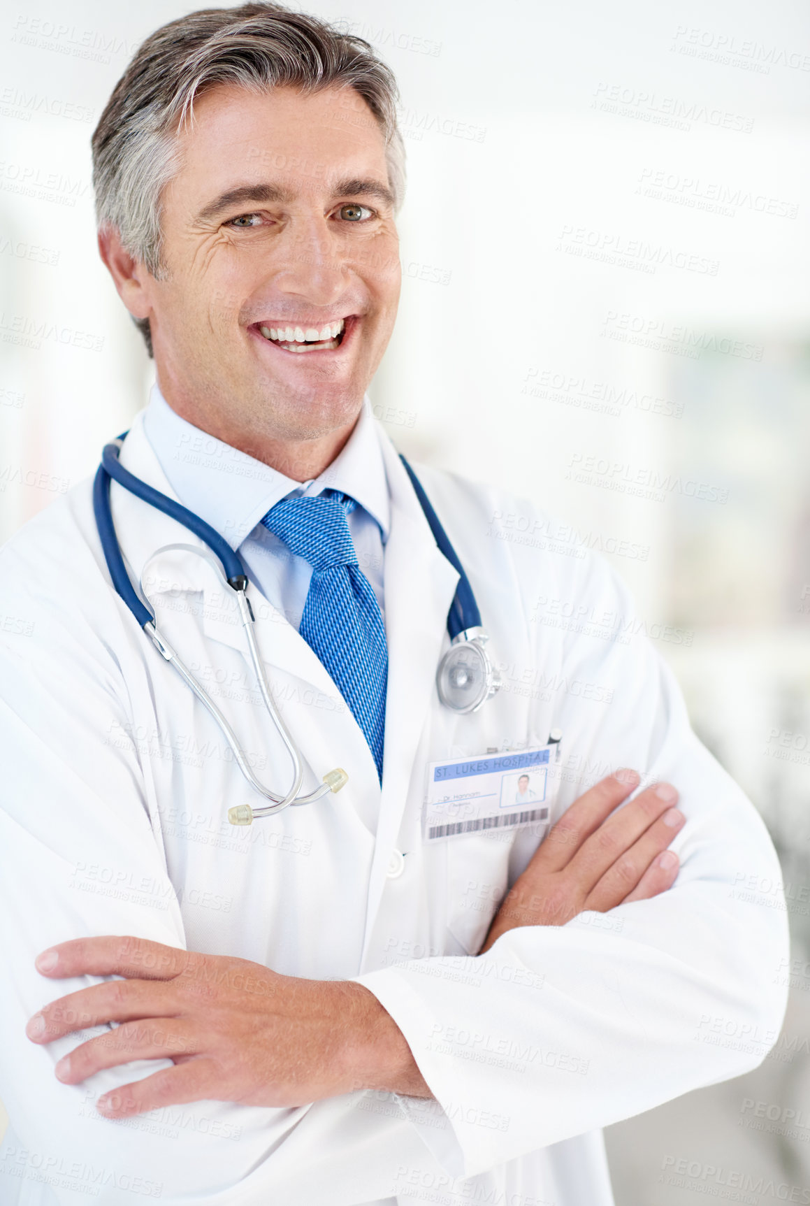 Buy stock photo Portrait of a male doctor standing in a hospital corridor