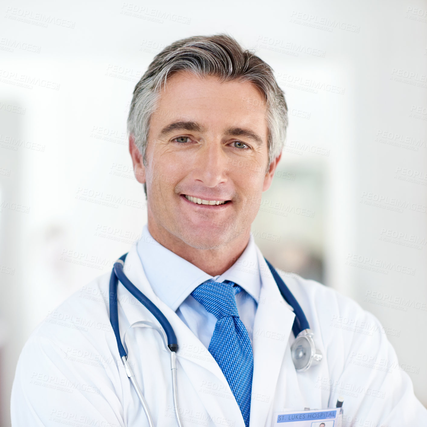 Buy stock photo Portrait of a male doctor standing in a hospital corridor