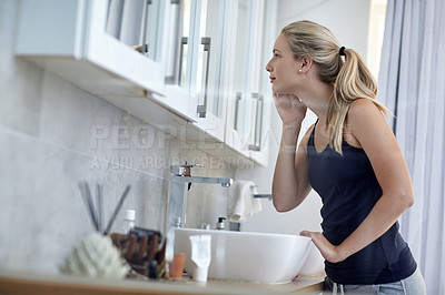 Buy stock photo Shot of an attractive young woman in her bathroom