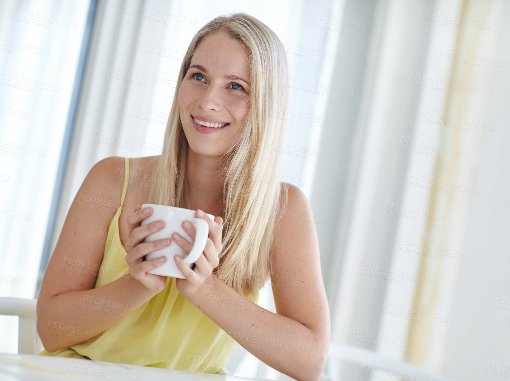 Buy stock photo Shot of an attractive young woman drinking a coffee at home