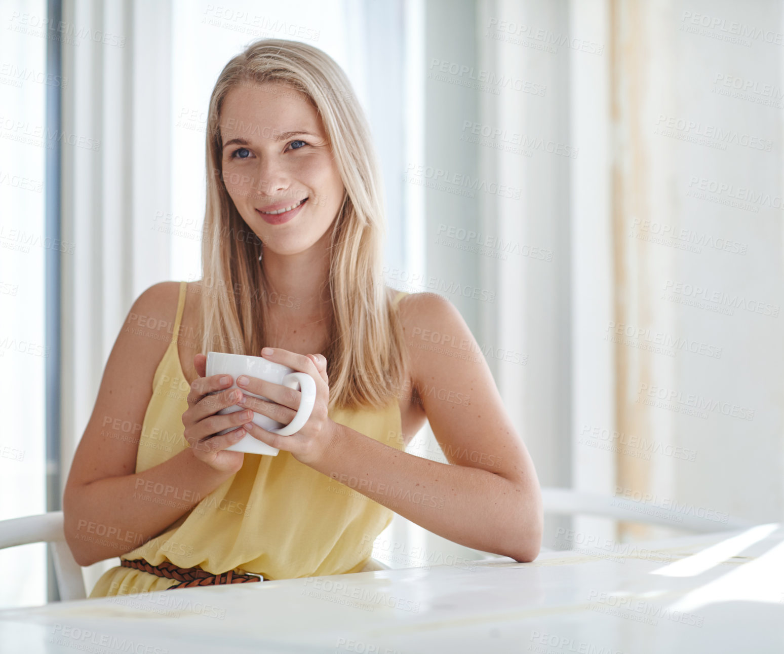 Buy stock photo Shot of an attractive young woman drinking a coffee at home